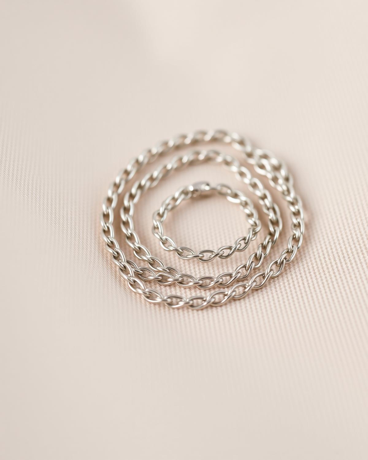 Fine chain coiled on pale linen